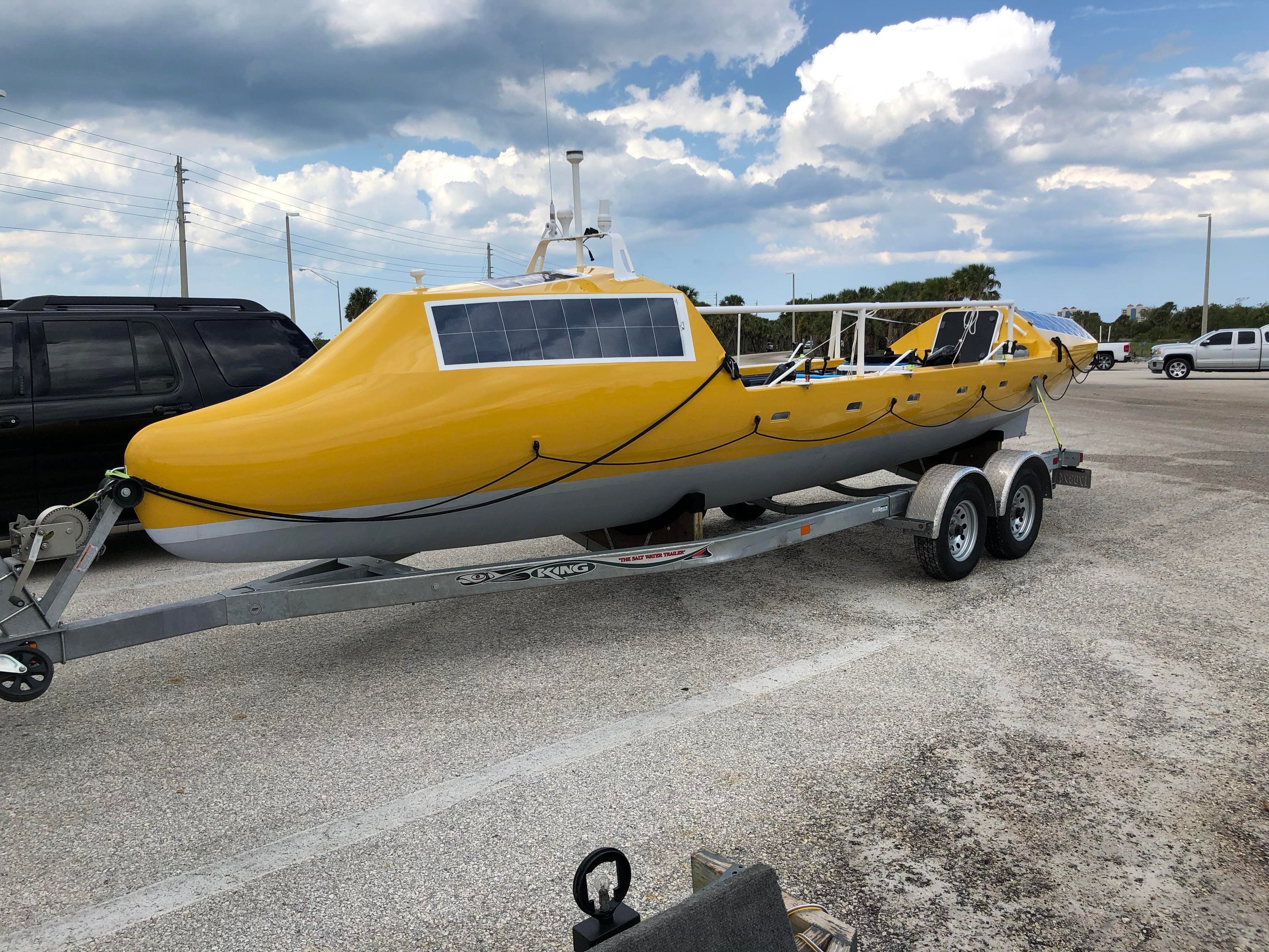 Nimbus on its trailer with its solar panels and cabins visible